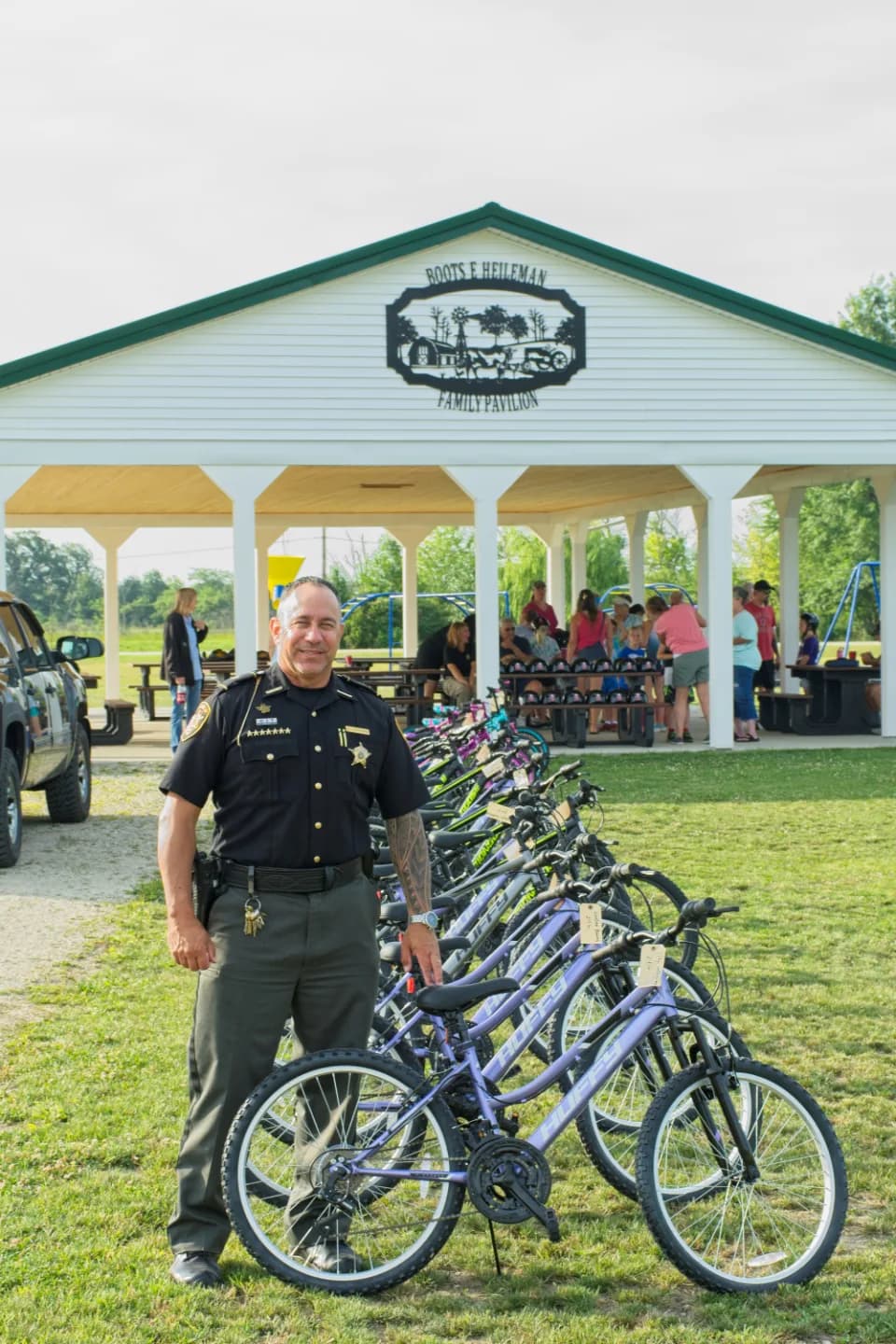 Sheriff Stephen Levorchick beside bicycles at a community bike-safety event