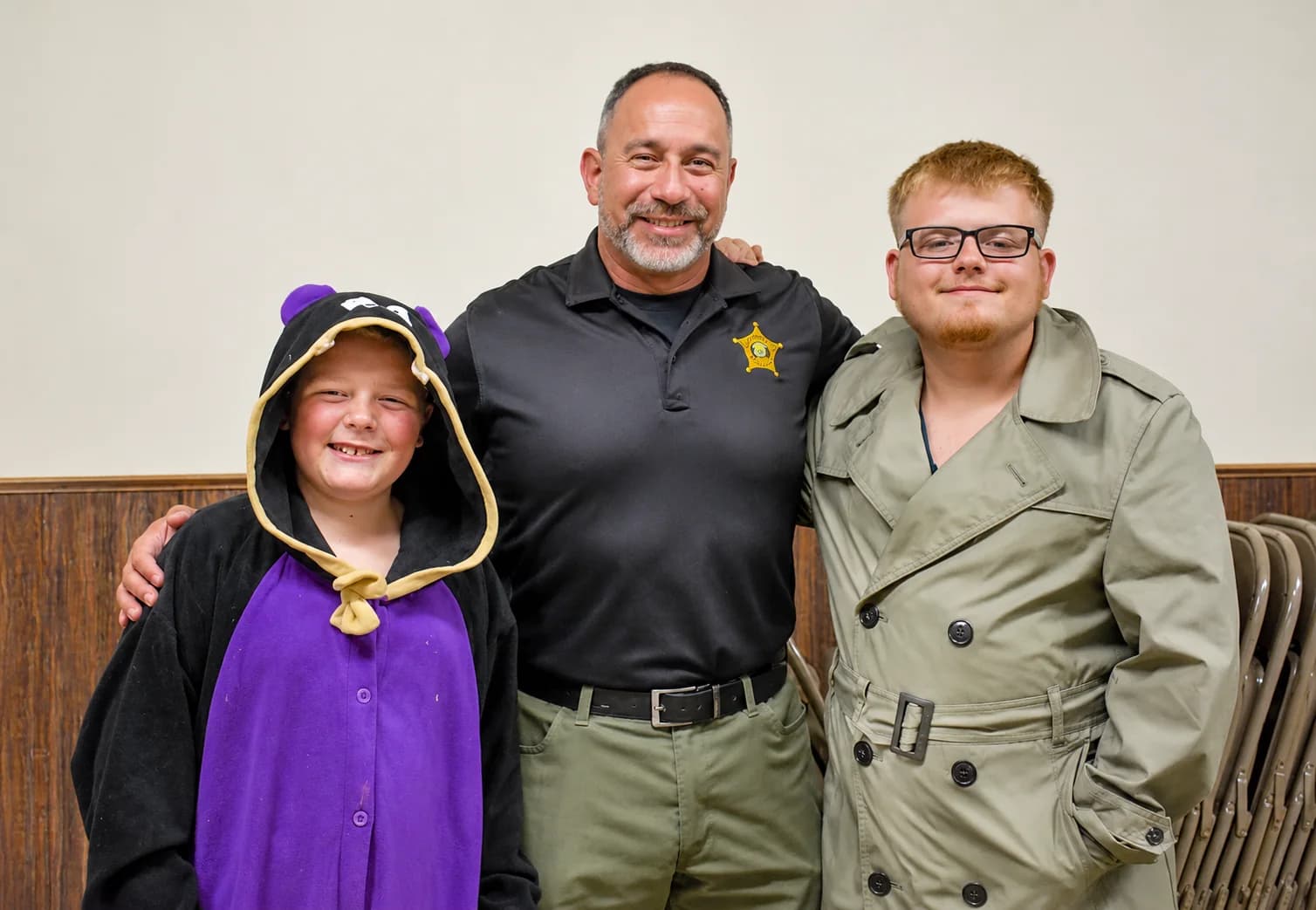 Stephen Levorchick with two community members at an indoor event